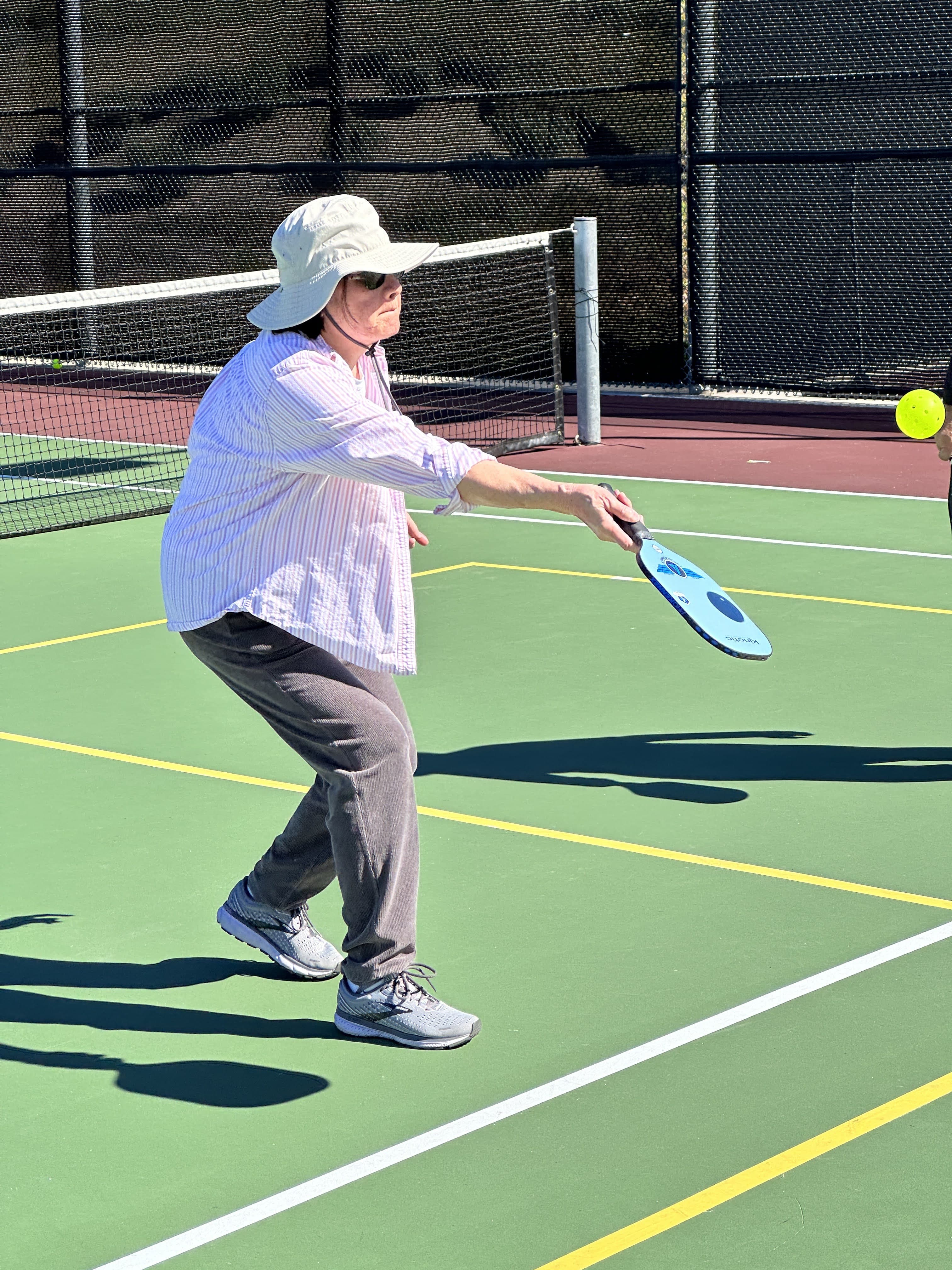 A player lunges into a crisp forehand, paddle meeting the ball.
